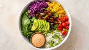 High Protein Taco Bowls High Protein Taco Bowl with cilantro lime rice, vegan chorizo, black beans, and salsa crema