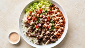 Steak Burrito Bowl Steak burrito bowl with cilantro lime rice, marinated flank steak, and chipotle cream