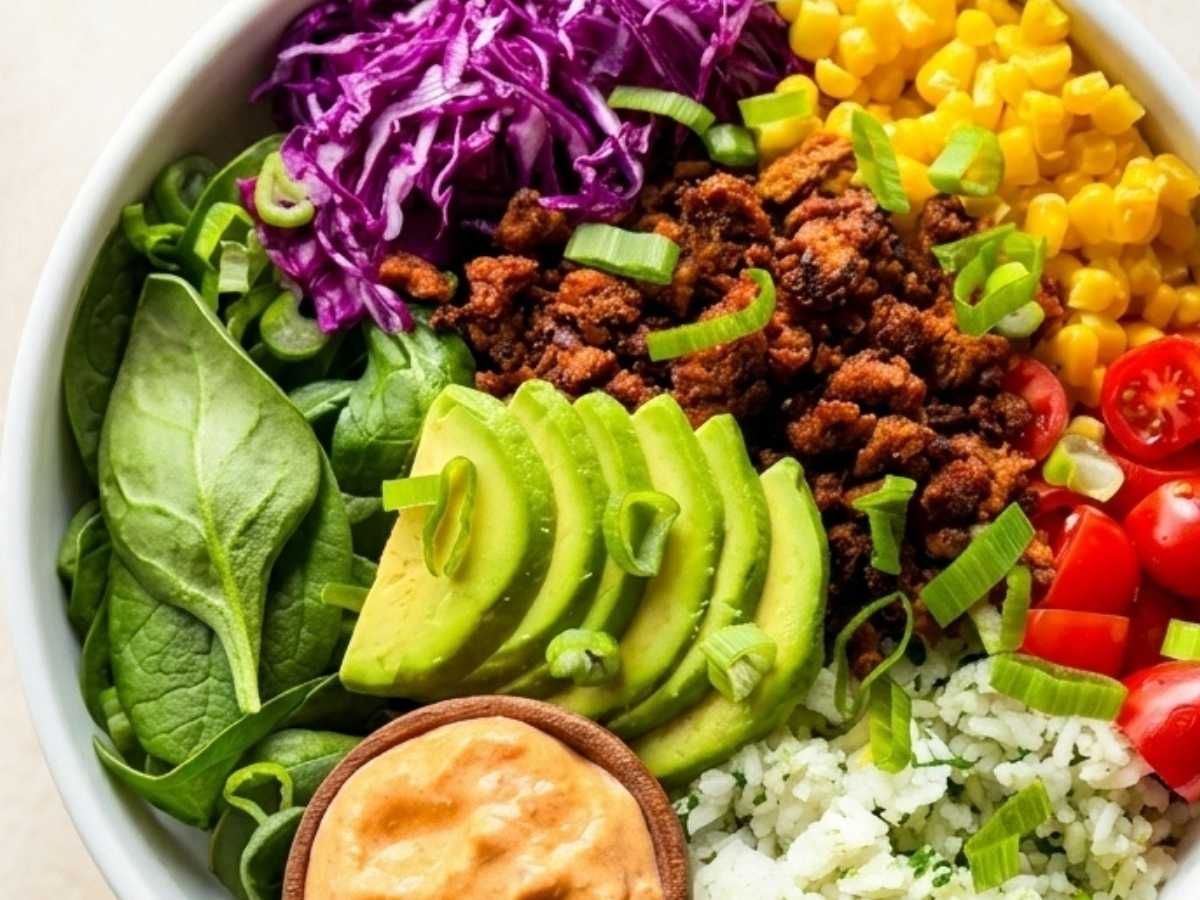 Close up of High Protein Taco Bowl topped with spicy salsa crema drizzle