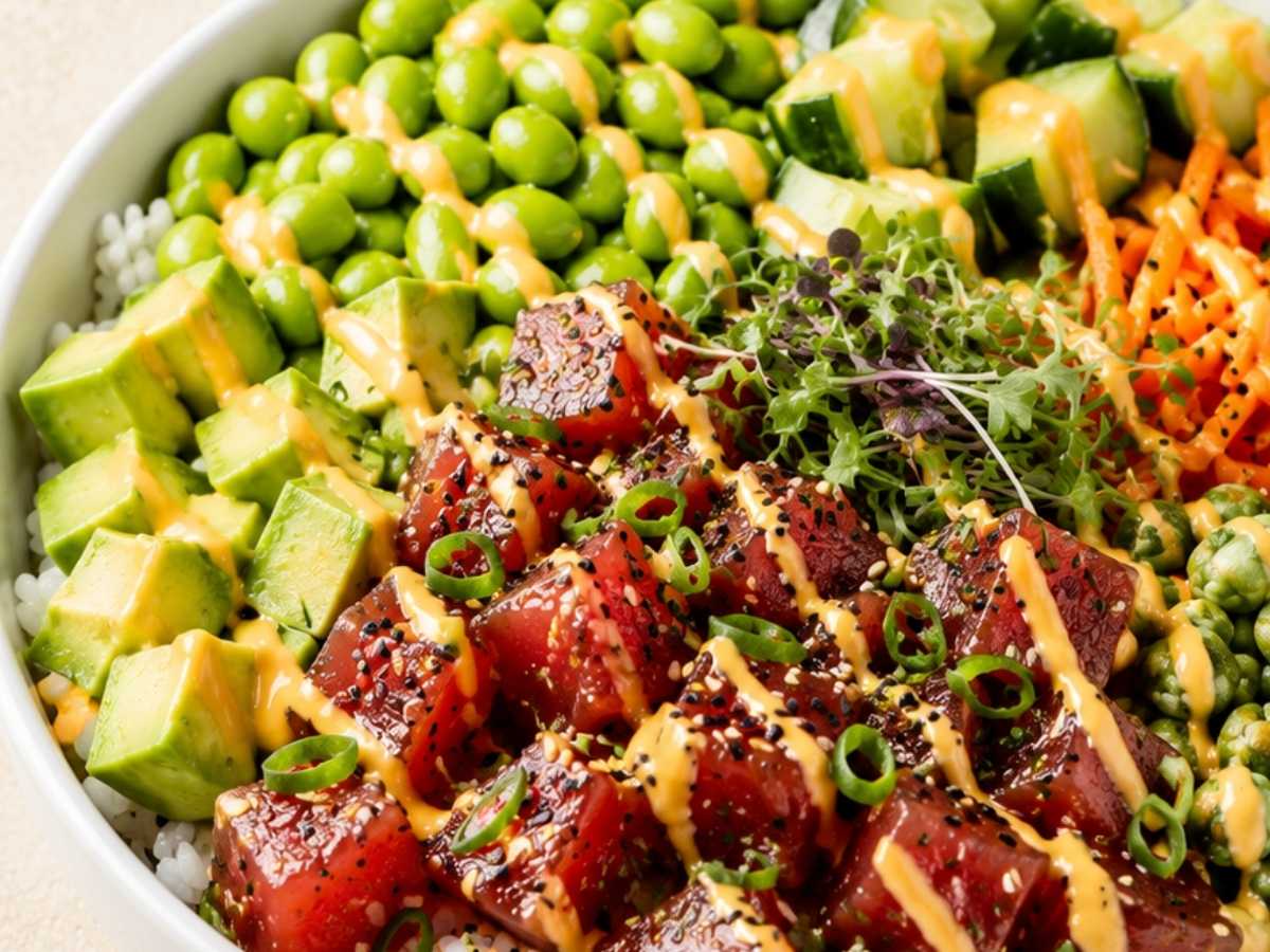 Close-up of ahi tuna poke bowl showing marinated tuna cubes, avocado, and sesame seeds