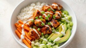 Buffalo Chicken Protein Bowl Finished Buffalo Chicken Protein Bowl with crispy chicken, rice, celery, and carrots