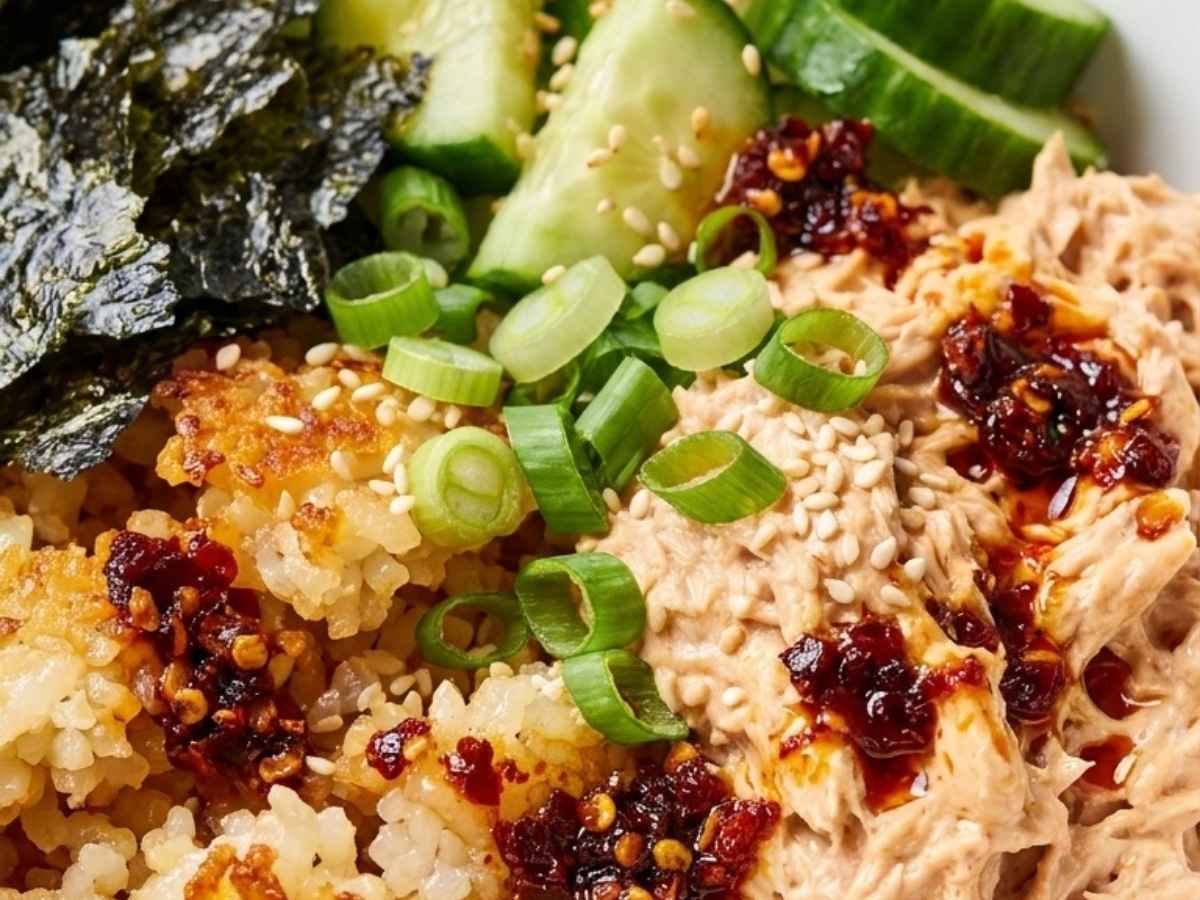 Close-up of crispy golden pan-fried rice and spicy mayo tuna in a sushi bowl