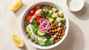 Mediterranean Quinoa Bowl Mediterranean quinoa bowl with smoky chickpeas, avocado, cucumber, and garlic yogurt sauce
