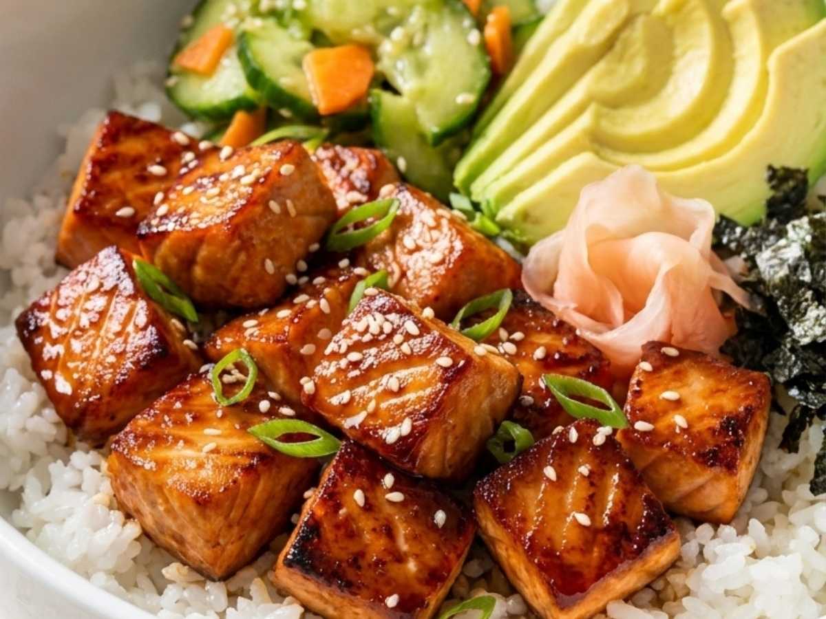 Closeup of salmon sushi bowl with caramelized salmon and cucumber salad