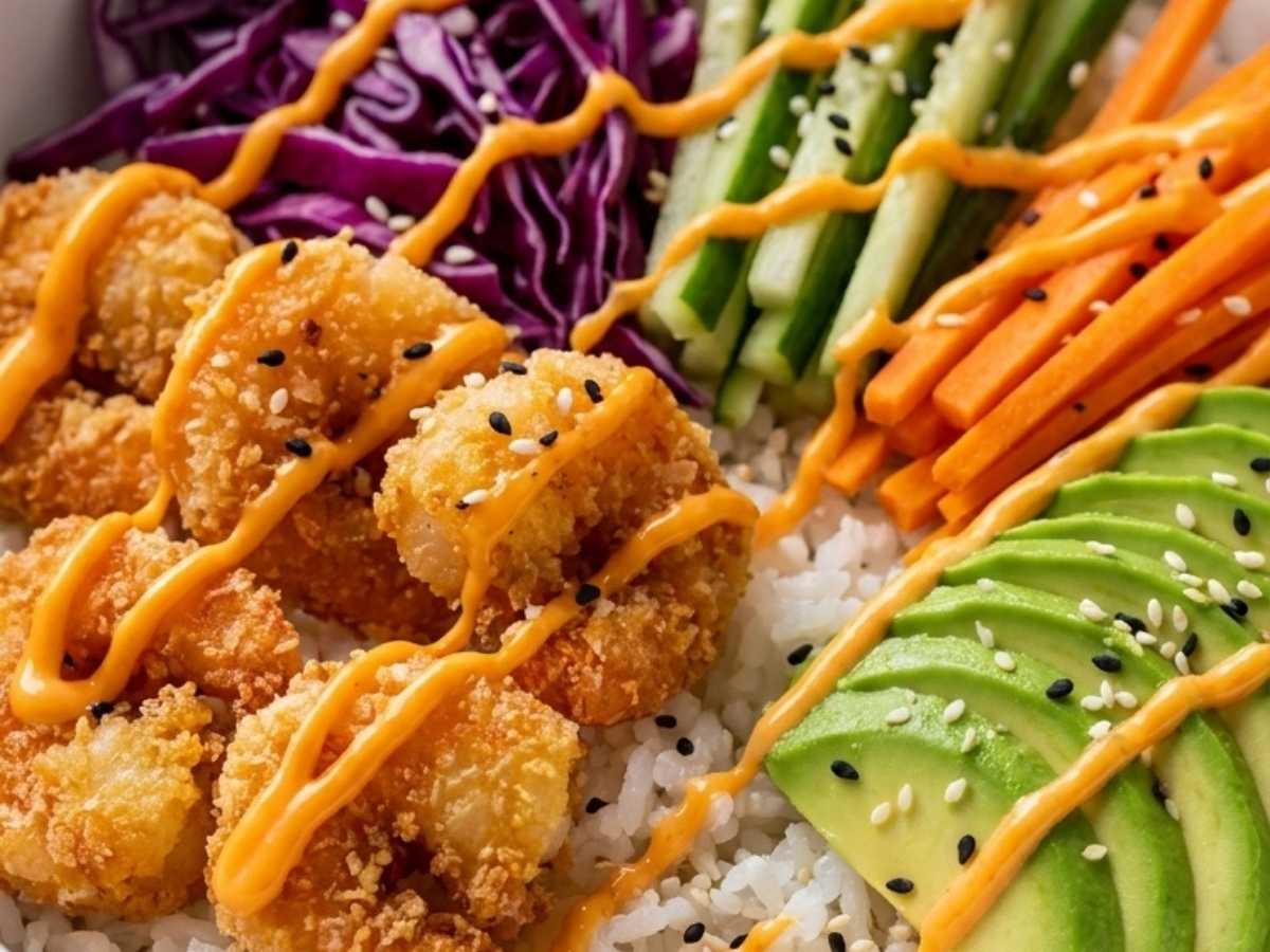 Close up of crispy shrimp and spicy mayo drizzle on a dynamite shrimp sushi bowl